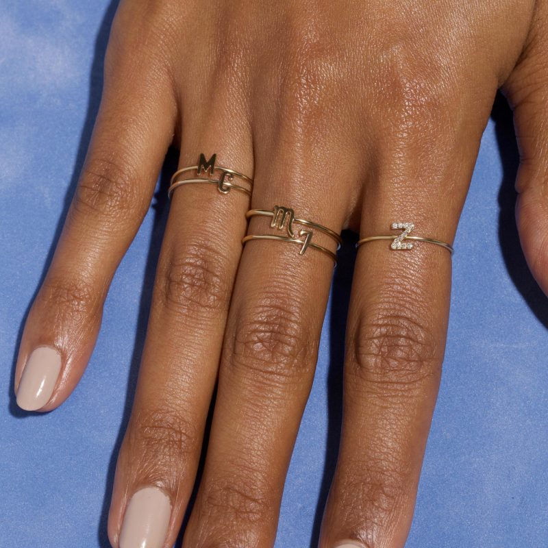 GOLD INITIAL RING ON BODY