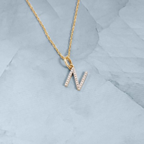 LARGE PAVE DIAMOND INITIAL CHARM NECKLACE STILL LIFE