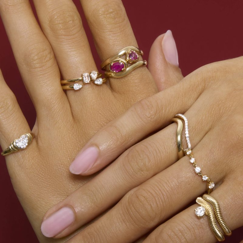 STONE AND STRAND RINGS ON HANDS