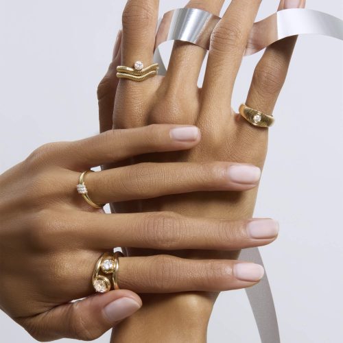 STONE AND STRAND RINGS ON MODELS HANDS